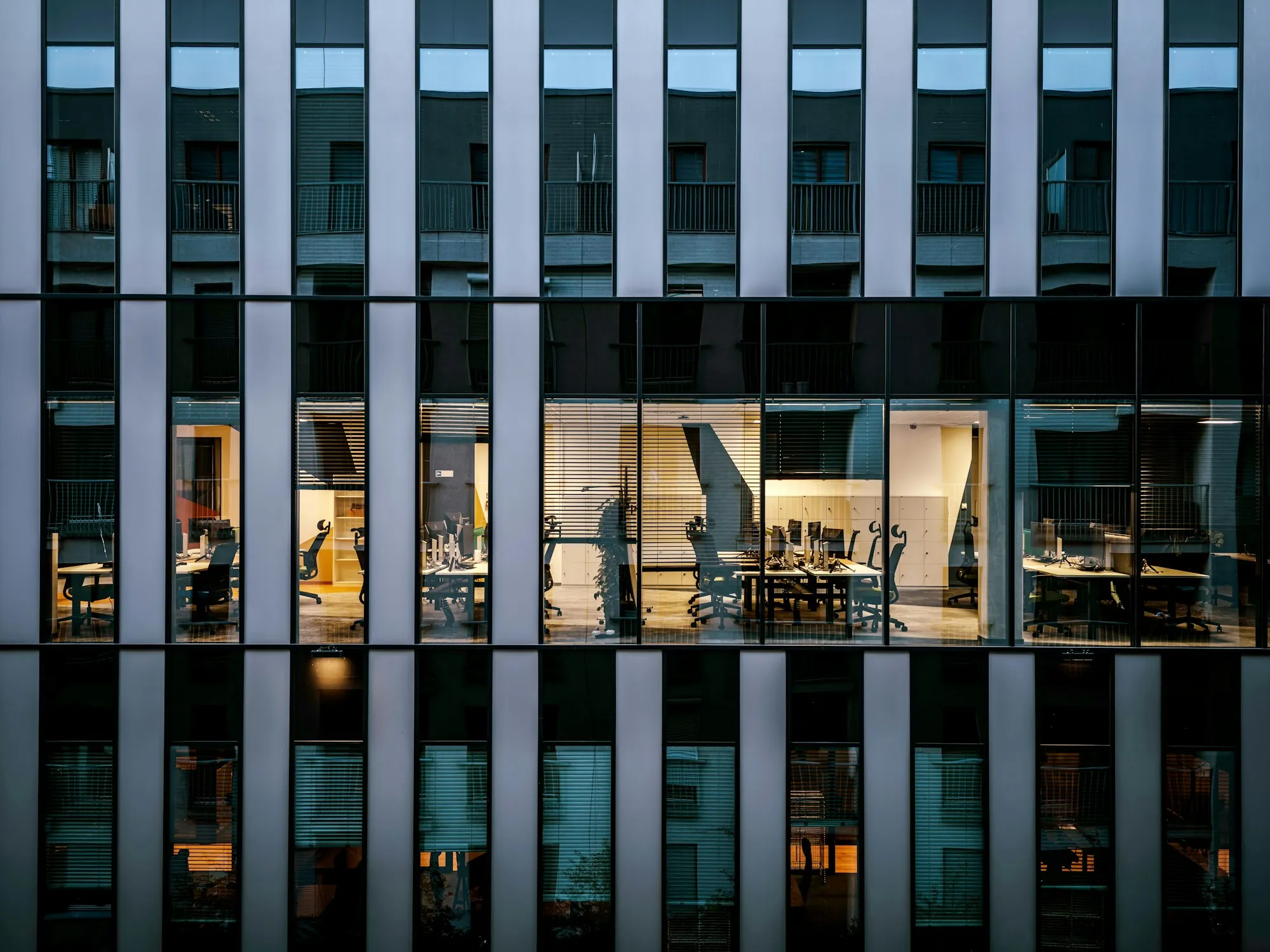 Office building facade lit up at dusk