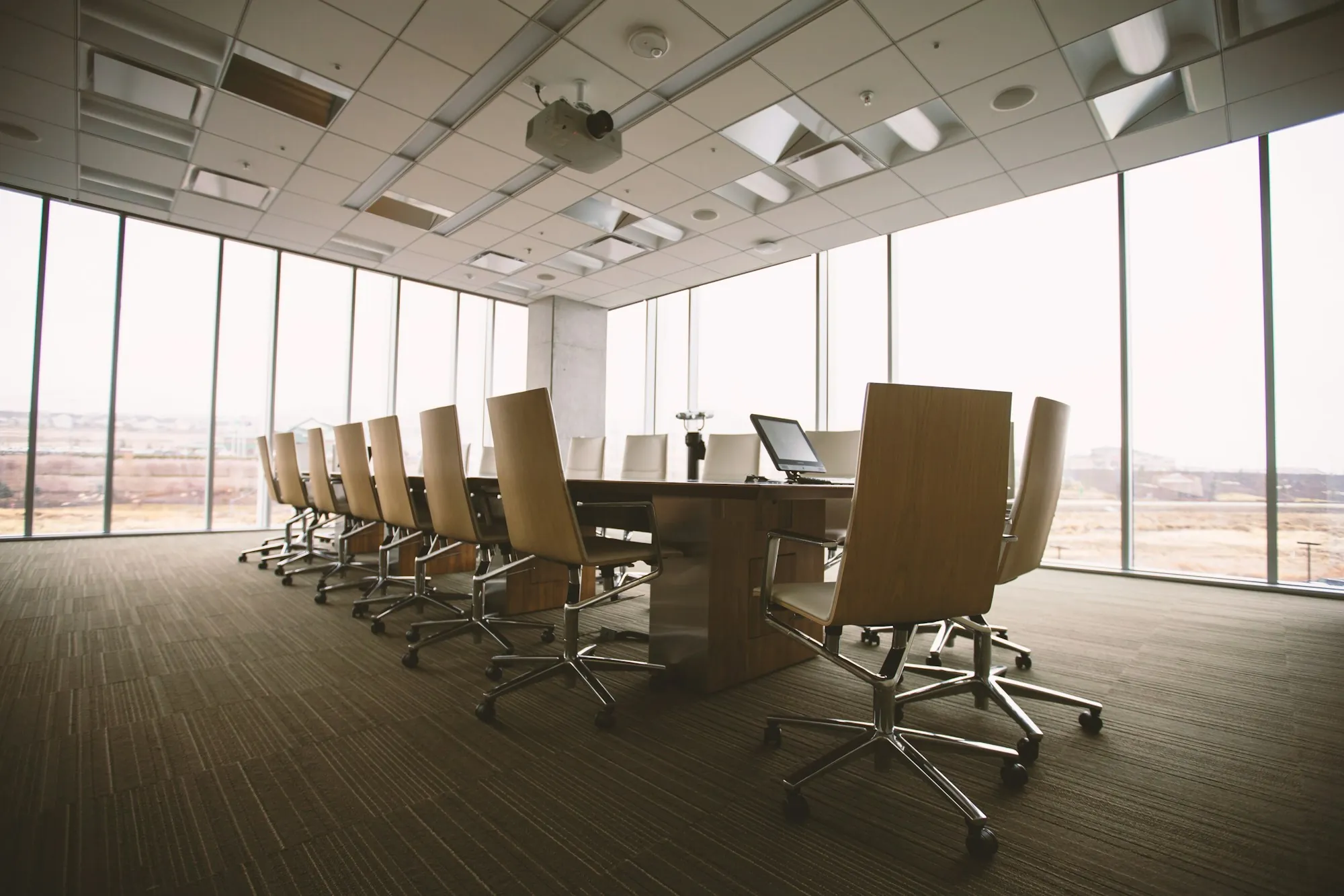 Meeting room with tall windows and rows of chairs