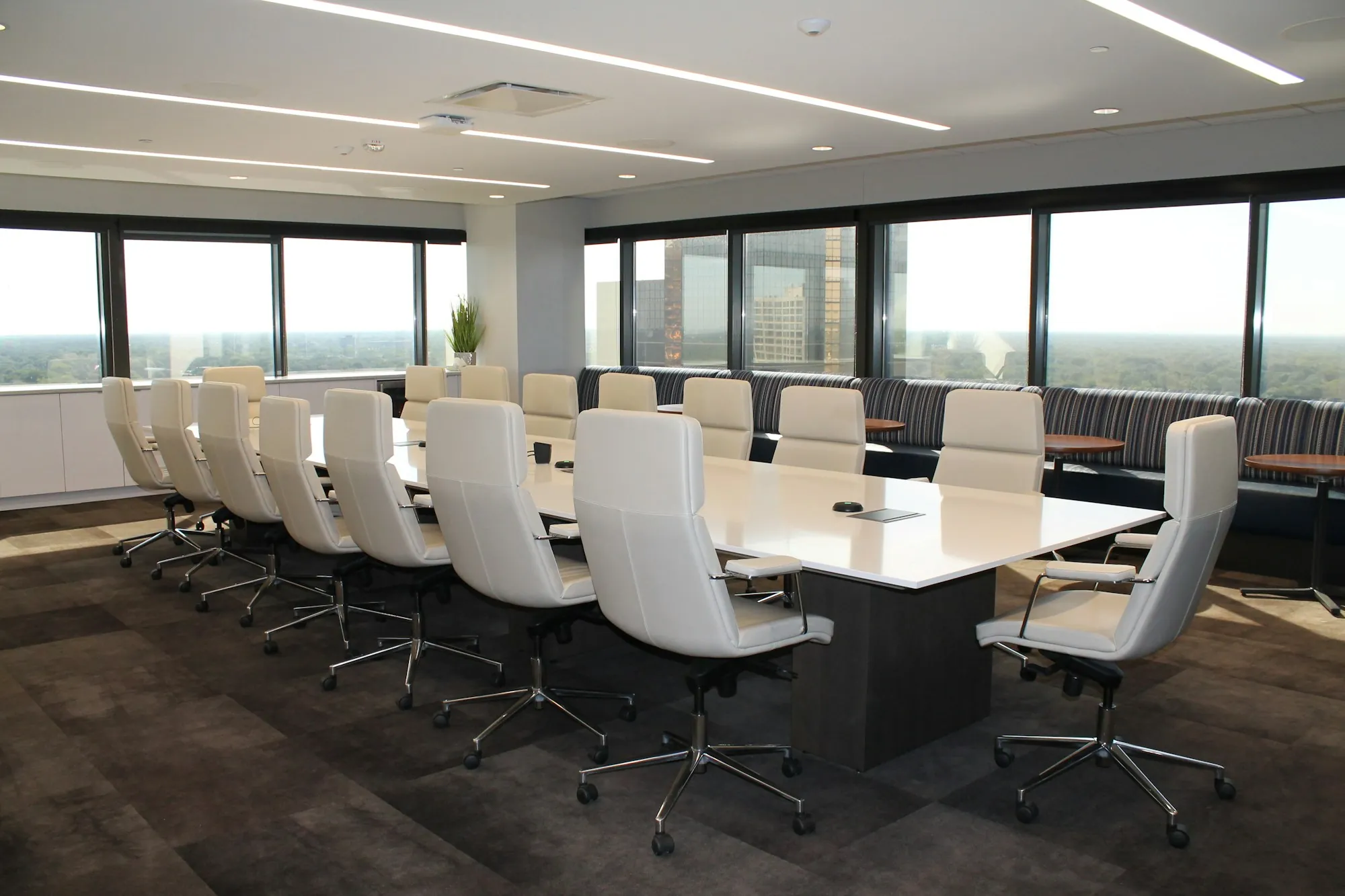 Boardroom with white chairs and panoramic windows